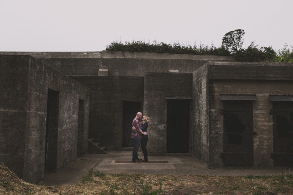 couple standing at abandoned military bunkers in san francisco